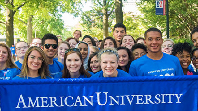 Diverse group of students holding sign of American University