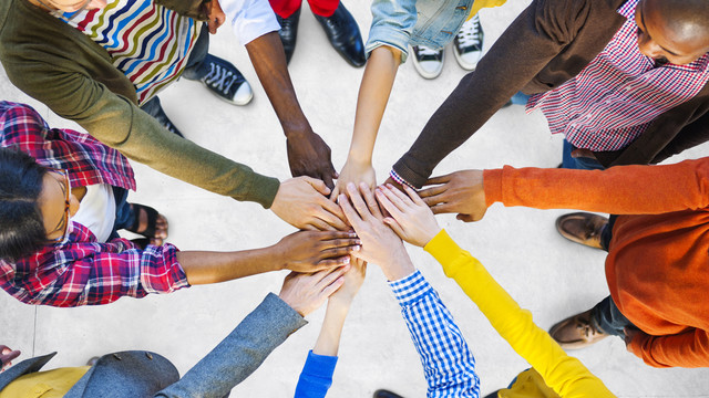 group of students holding their hands out
